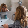 elderly woman brushing teeth bathroom Saúde e Bem-estar